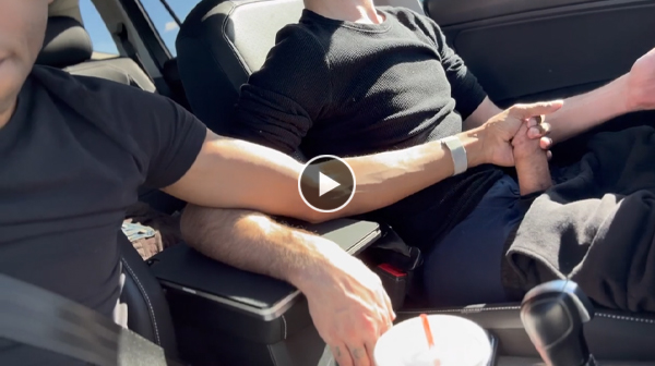 Two guys giving each other a handjob while driving